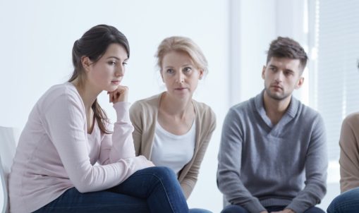 Support group for addiction listening to member during meeting